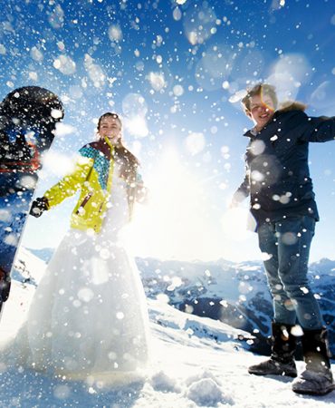 bride and groom in love throw snow background of the Alps Courchevel